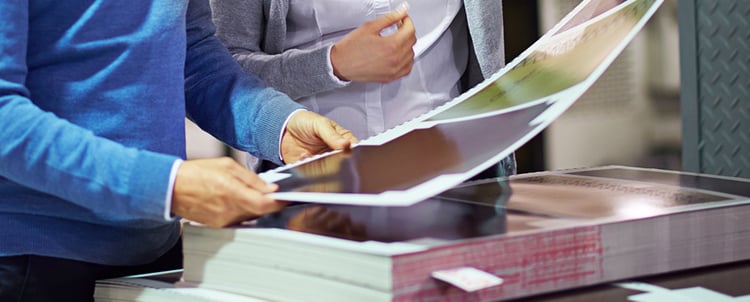 Image of woman inspecting glossy paper sheet