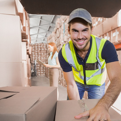 Delivery driver loading his van with boxes outside the warehouse